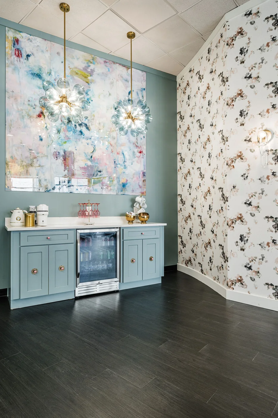 LUCiTE wall mural above a pale blue beverage bar, with butterfly wallpaper