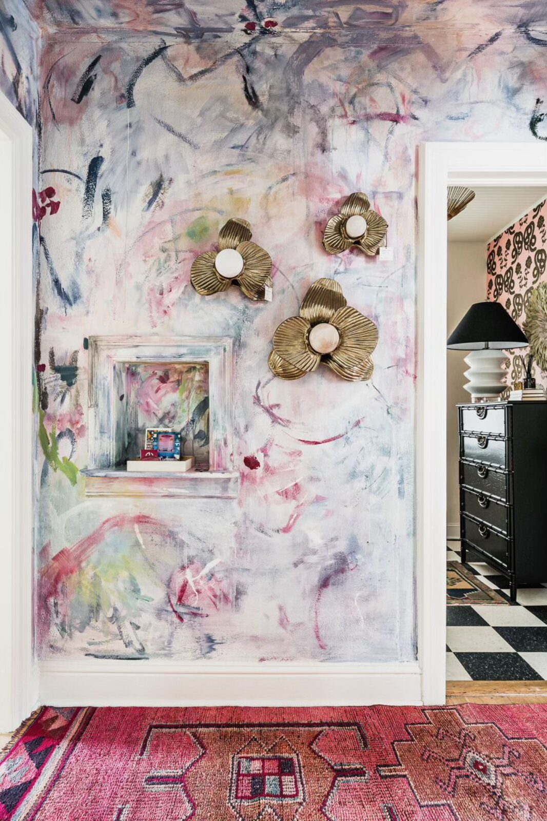 Gilded floral wall sculptures over a soft abstract mural