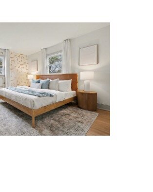 A serene bedroom staged by Summer Savin, prepared to show at its best