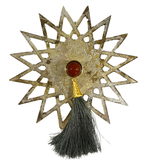 gold sunburst shape lucite backplate with red stone knob and grey tassel