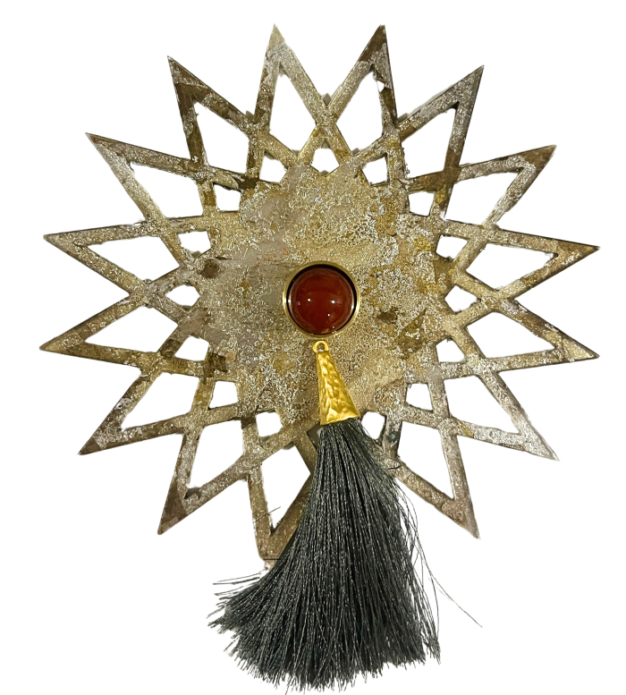 gold sunburst shape lucite backplate with red stone knob and grey tassel